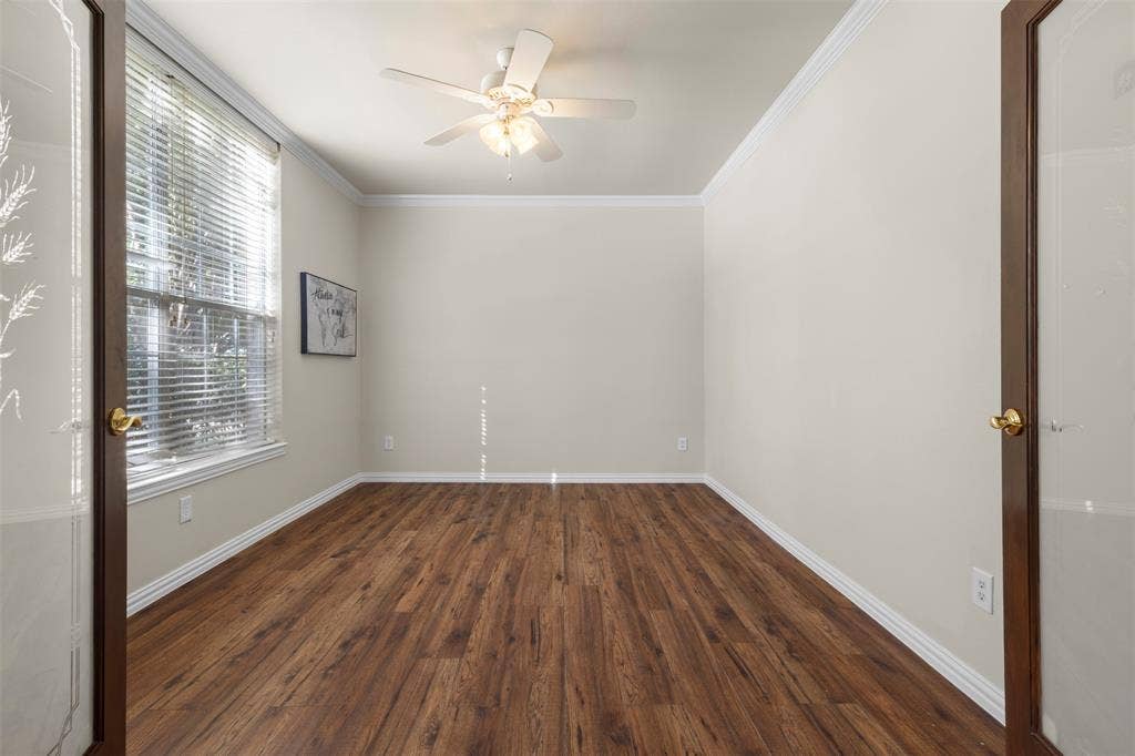 5401 Wolcott Place, Richardson, TX 75082 Wood-finish flooring, crown molding, and a ceiling fan