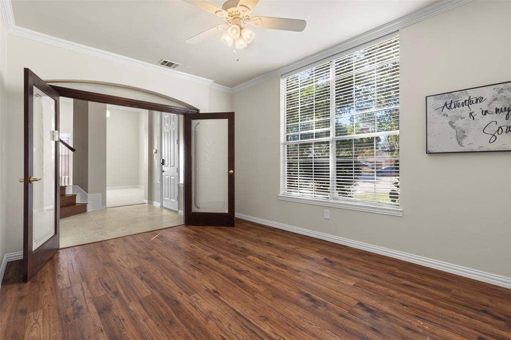 5401 Wolcott Place, Richardson, TX 75082 Wood-finish flooring with crown molding and baseboards