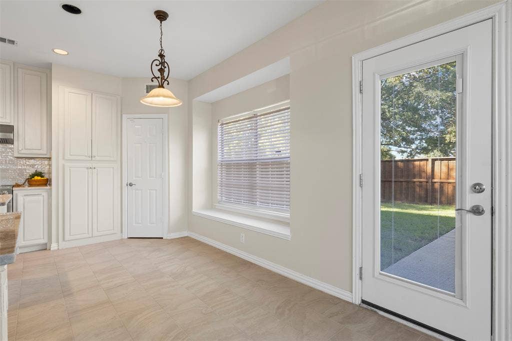 5401 Wolcott Place, Richardson, TX 75082 Light-toned tile flooring, recessed lighting, and a decorative pendant light fixture