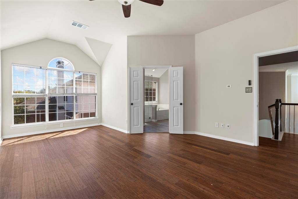 5401 Wolcott Place, Richardson, TX 75082 Vaulted ceiling, wood-finish flooring, architectural windows, ceiling fan, and double doors