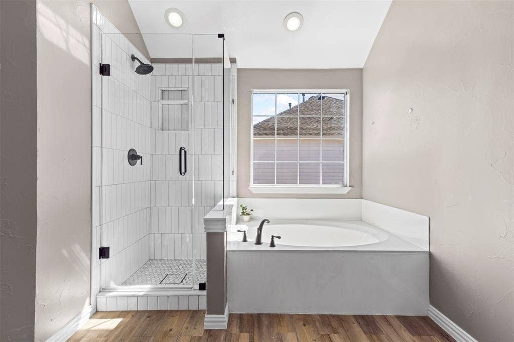 5401 Wolcott Place, Richardson, TX 75082 Glass-enclosed shower with vertical tile surround and black fixtures