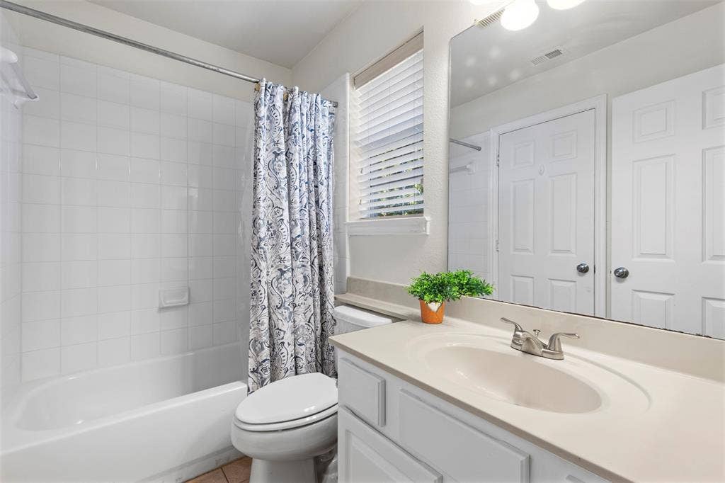 5401 Wolcott Place, Richardson, TX 75082 White paneled vanity with an integrated sink and brushed nickel faucet