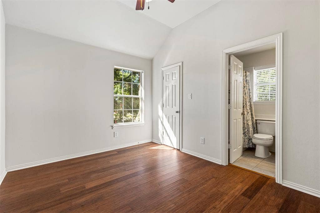5401 Wolcott Place, Richardson, TX 75082 Wood-finish flooring, vaulted ceiling, and a ceiling fan
