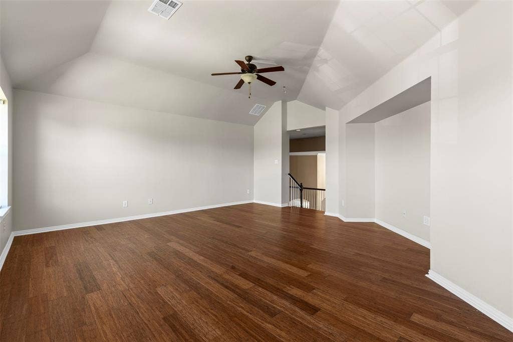 5401 Wolcott Place, Richardson, TX 75082 Vaulted ceiling with a ceiling fan, wood-finish flooring, and white trim
