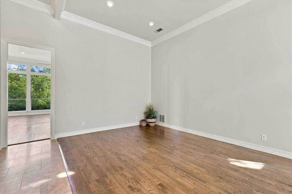 Hardwood flooring, crown molding, recessed lighting, and a vaulted ceiling