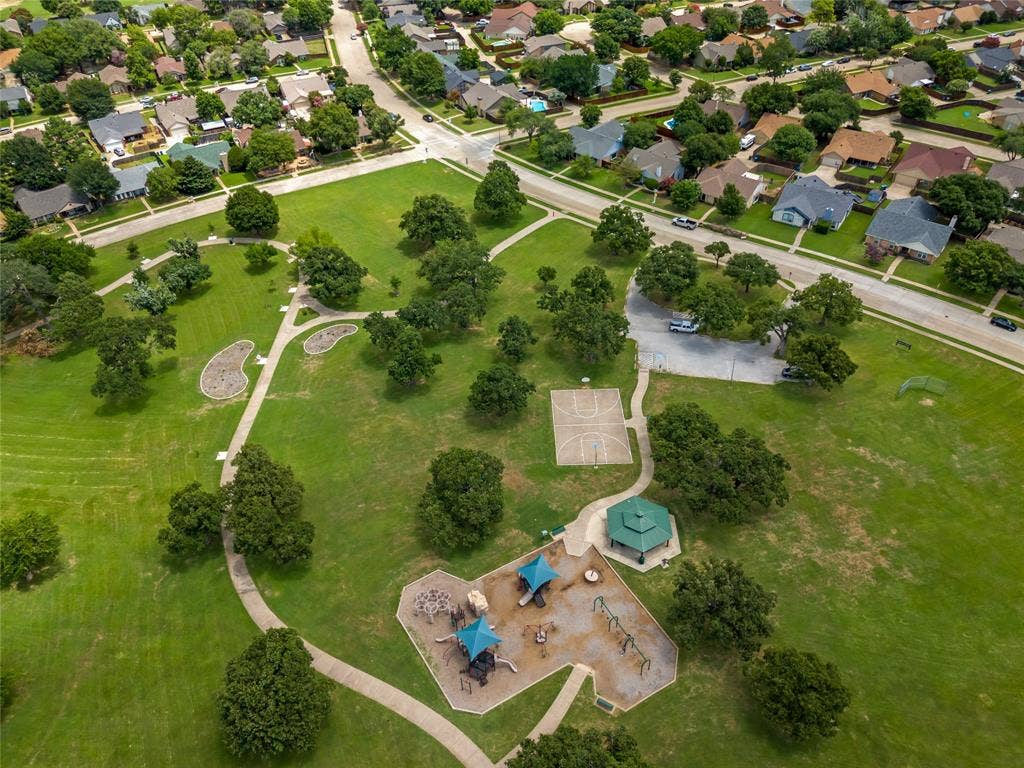 Across the street from park - expansive green space featuring a playground, basketball court, and walking paths