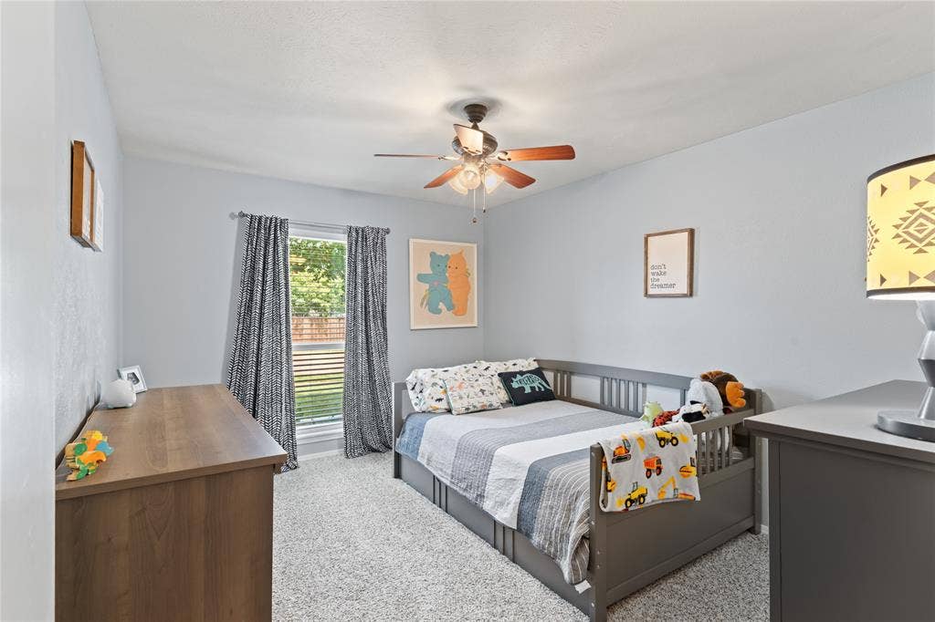 Bedroom 3 with plenty of natural light and ceiling fan.