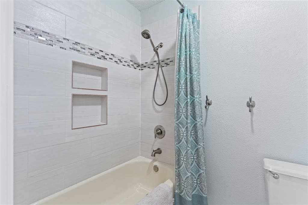Updated secondary bath with light and bright tile surround