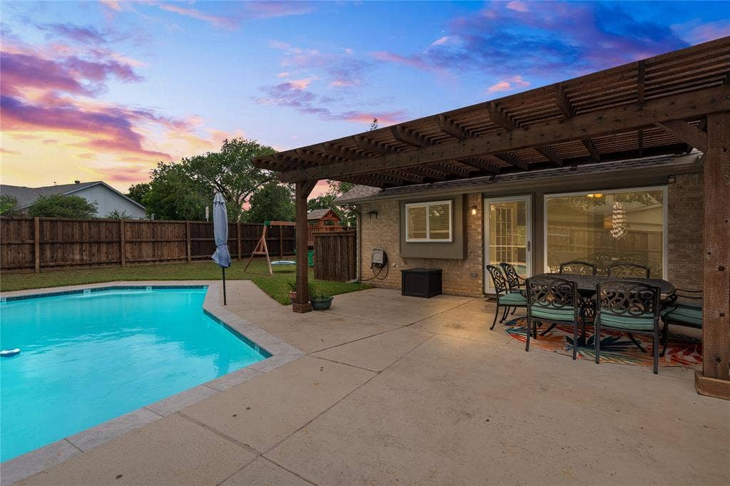 Patio featuring a wood pergola and an in-ground swimming pool