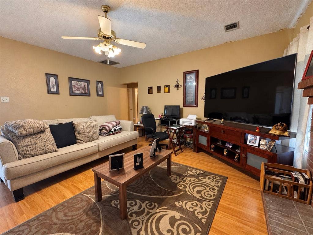 725 Andalusia Trail, DeSoto, TX 75115 Hardwood-finish flooring, ceiling fan with integrated lighting, and a built-in entertainment console
