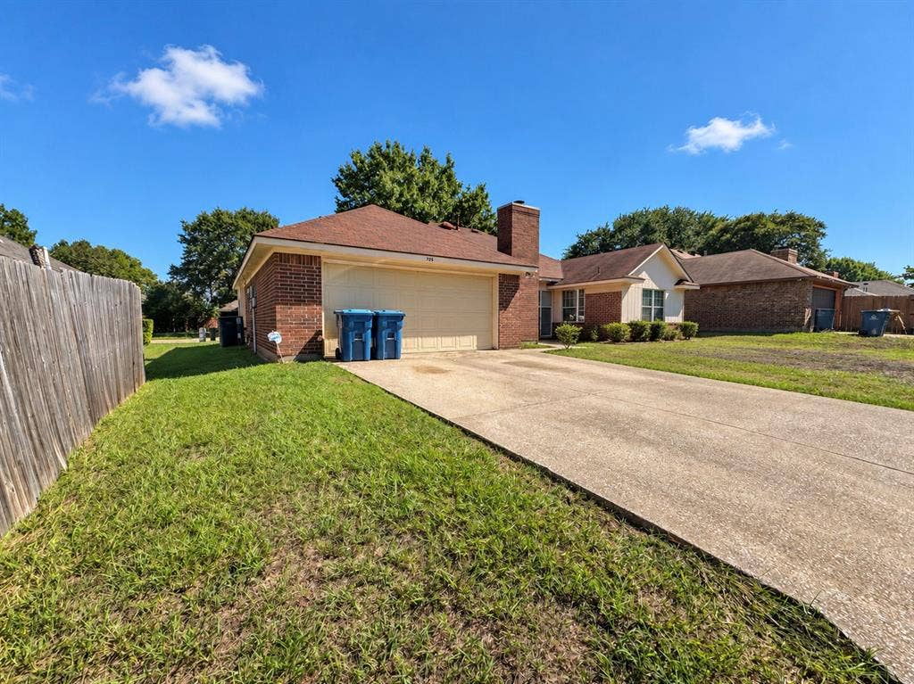 725 Andalusia Trail, DeSoto, TX 75115 Brick exterior with a concrete driveway, attached garage, and a wood privacy fence