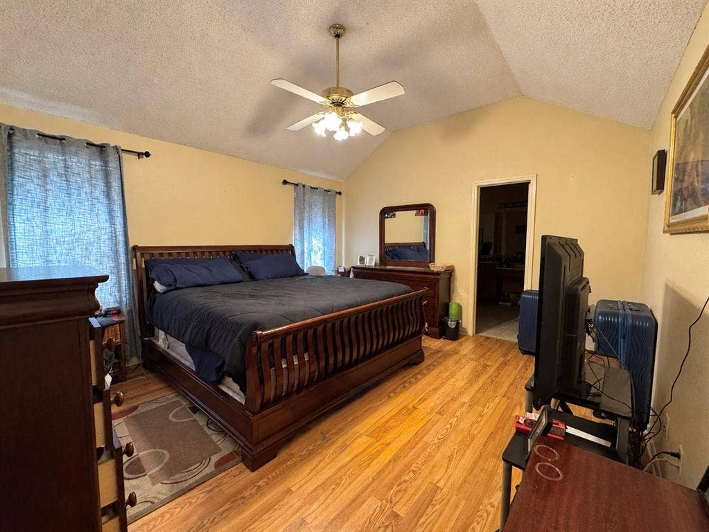 725 Andalusia Trail, DeSoto, TX 75115 Vaulted ceiling with a ceiling fan light fixture, wood-finish flooring, and recessed doorway