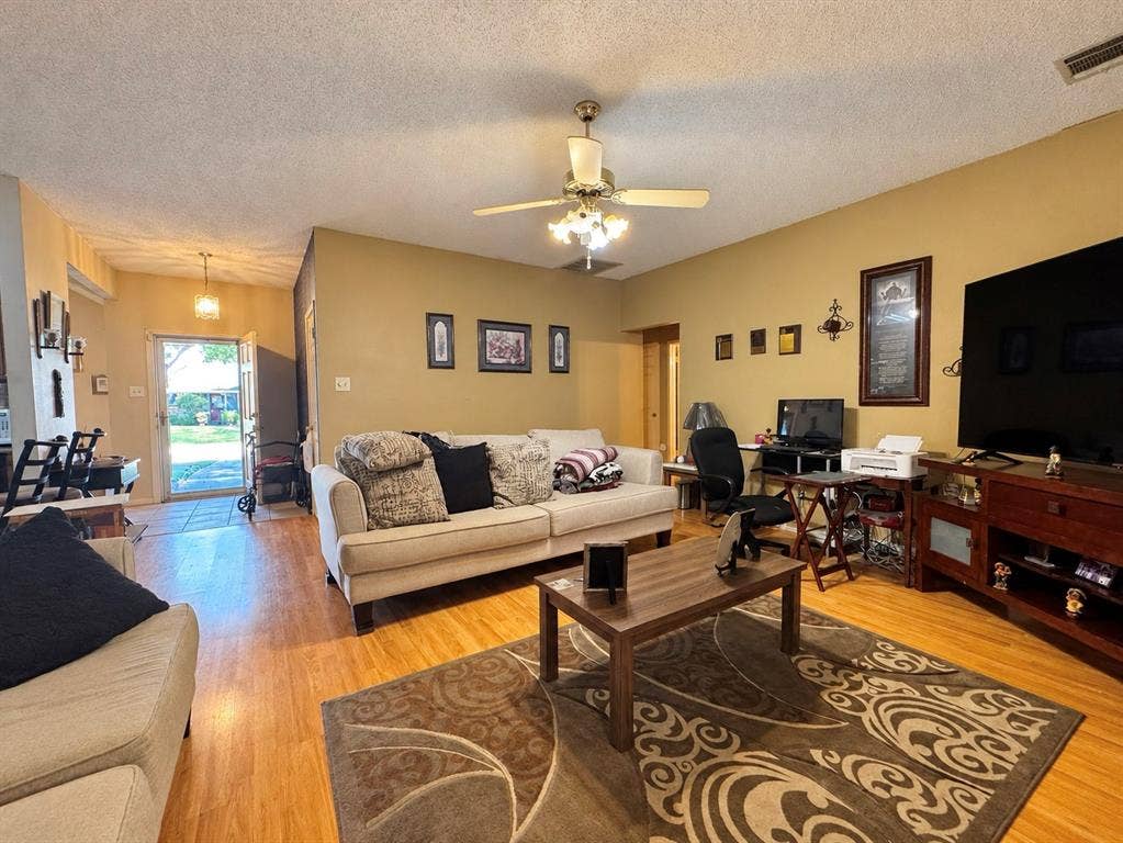 725 Andalusia Trail, DeSoto, TX 75115 Wood-finish flooring throughout, ceiling fan with integrated lighting, and neutral wall tones