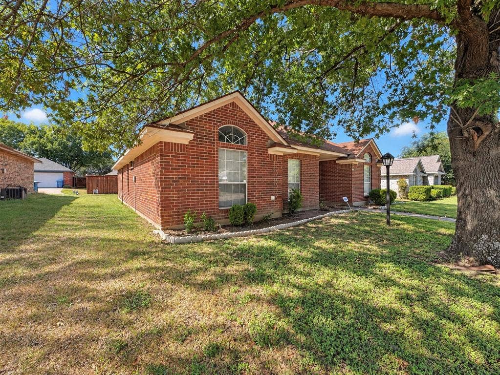 725 Andalusia Trail, DeSoto, TX 75115 Red brick exterior with an arched window and covered front entry