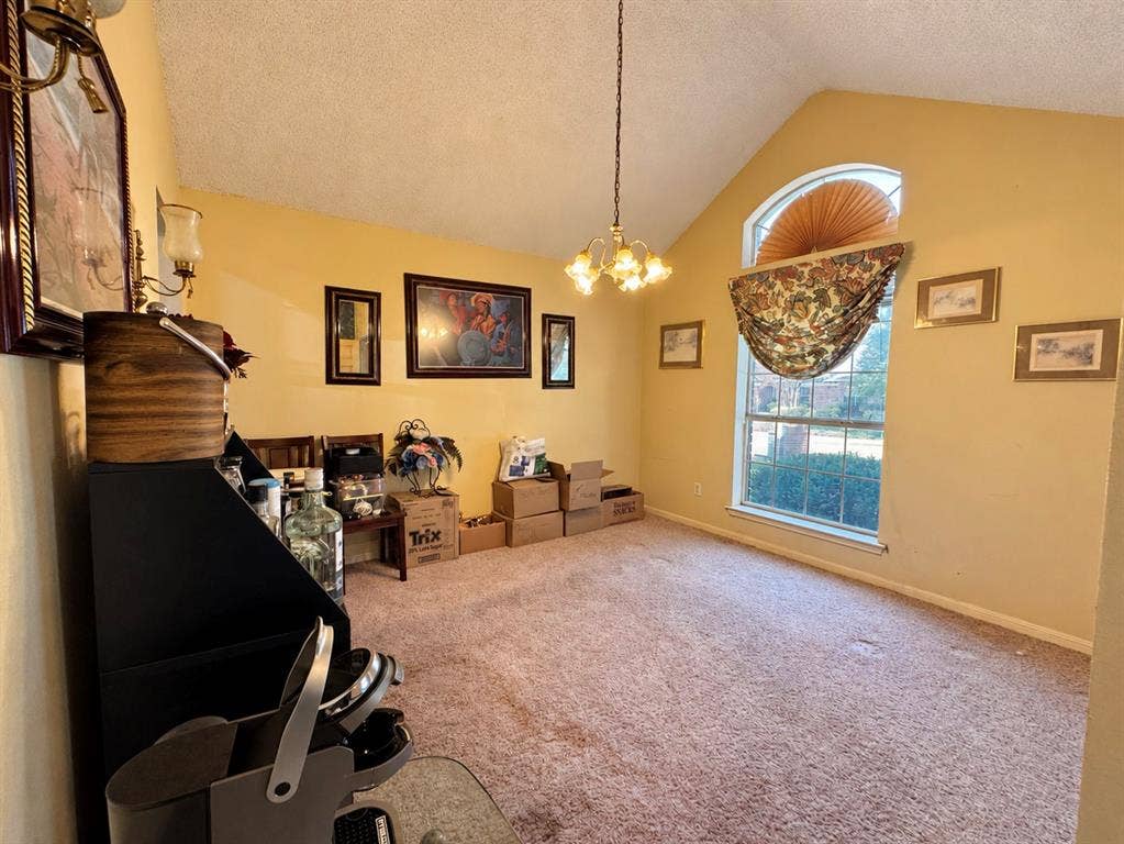 725 Andalusia Trail, DeSoto, TX 75115 Vaulted ceiling with an arched window, central chandelier, and wall-mounted sconce