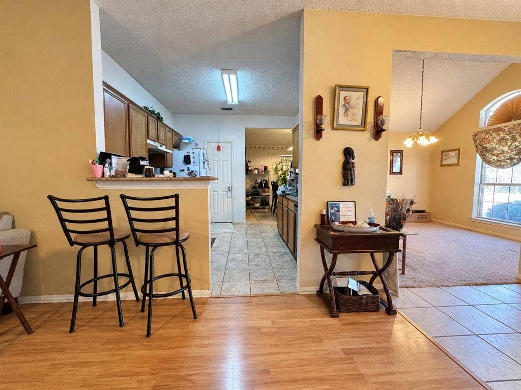 725 Andalusia Trail, DeSoto, TX 75115 Kitchen pass-through with wood-finish flooring, tile flooring, and wood cabinetry