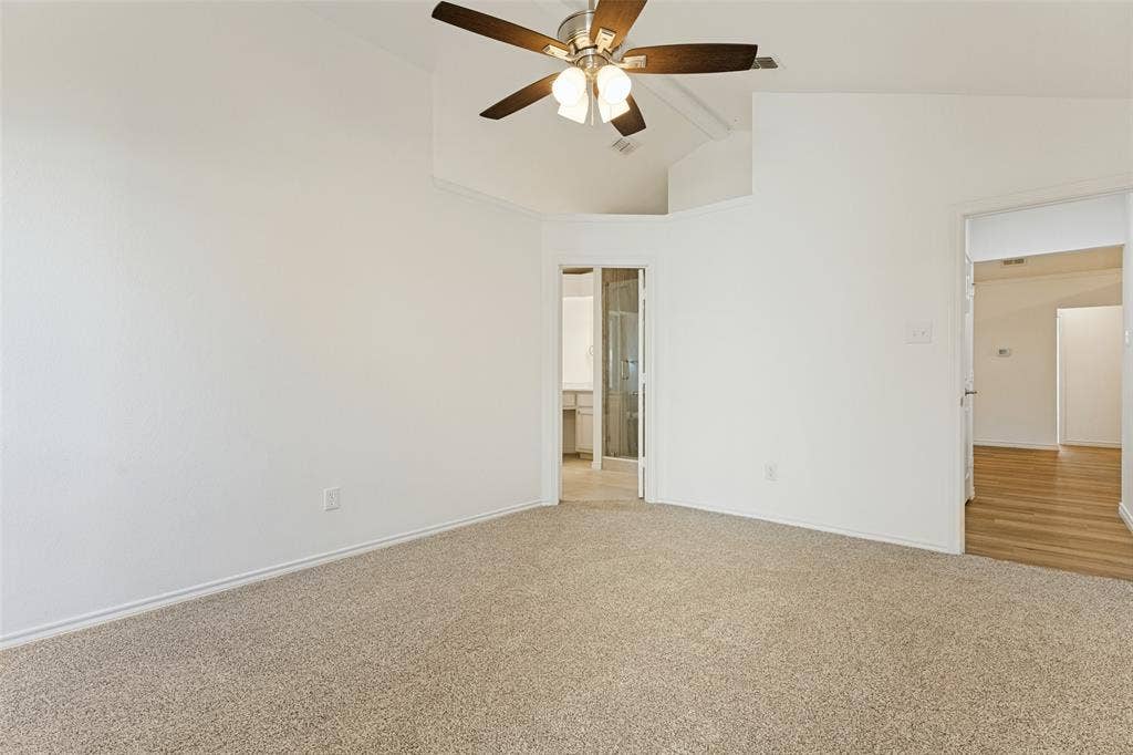 7440 Bear Lake Drive, Fort Worth, TX 76137 Vaulted ceiling with an integrated ceiling fan, light-toned carpeting, and white painted walls