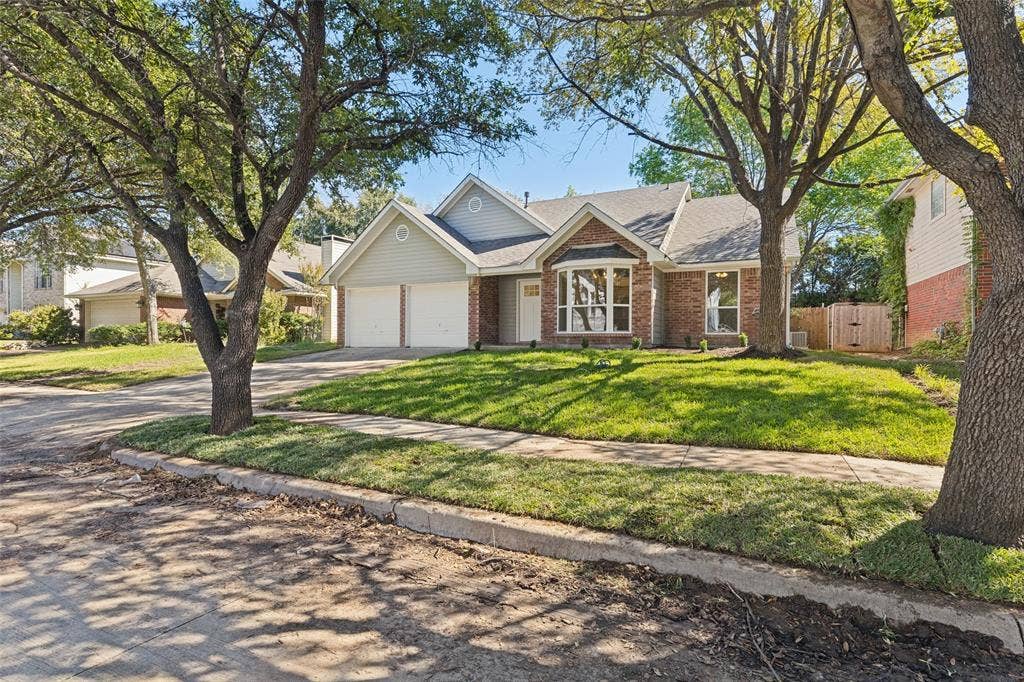 7440 Bear Lake Drive, Fort Worth, TX 76137 Red brick and siding exterior with a shingle roof