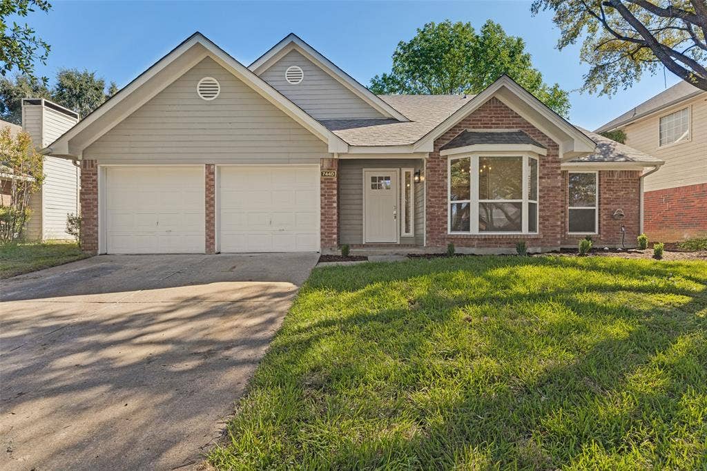7440 Bear Lake Drive, Fort Worth, TX 76137 Brick and siding exterior featuring a two-car garage, bay window, and gabled roofline