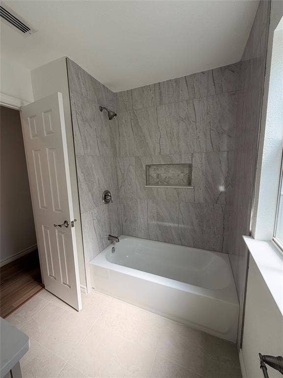 7440 Bear Lake Drive, Fort Worth, TX 76137 Bathtub shower with light-toned wall tile, recessed shower niche, and brushed nickel fixtures