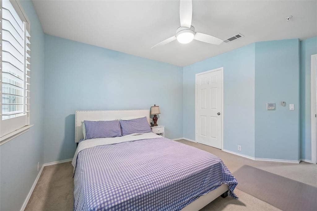 2209 Stonepark Place, McKinney, TX 75071 White plantation shutters, ceiling fan with integrated lighting, wall-to-wall carpeting, and a paneled interior door
