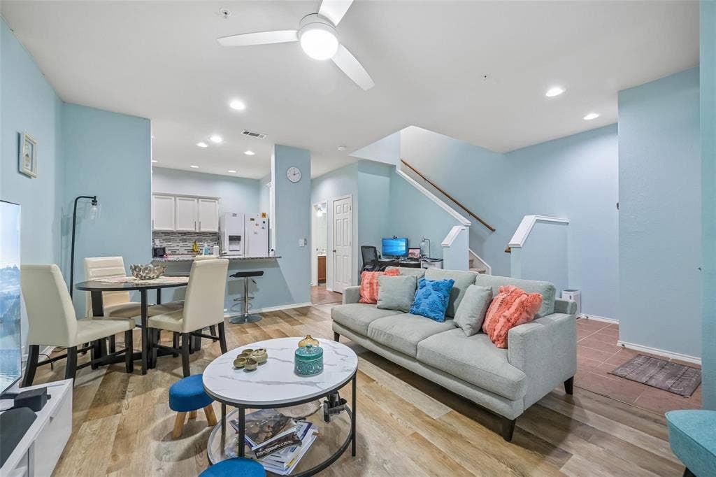 2209 Stonepark Place, McKinney, TX 75071 Wood-finish flooring, recessed ceiling lighting, ceiling fan, and a kitchen pass-through with a built-in breakfast bar