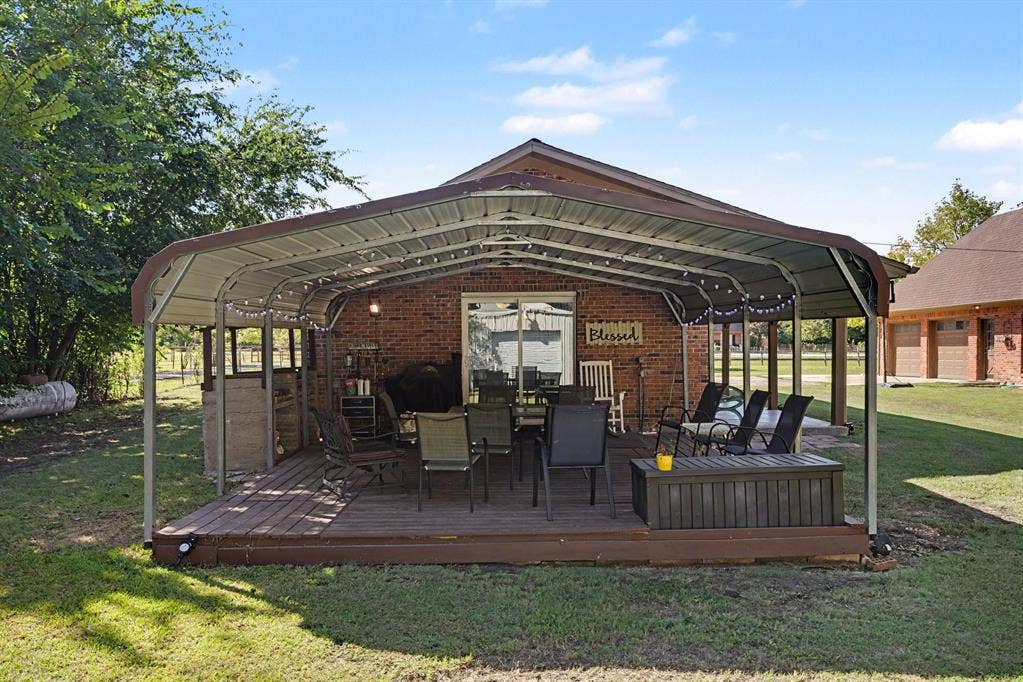 26 Brookhaven Drive, Lucas, TX 75002 Covered back patio with a wood-finish deck and brick exterior