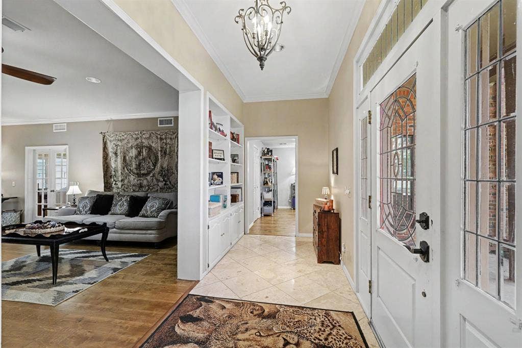 26 Brookhaven Drive, Lucas, TX 75002 Entryway featuring leaded glass doors and side panels, decorative chandelier, built-in shelving, and tile flooring