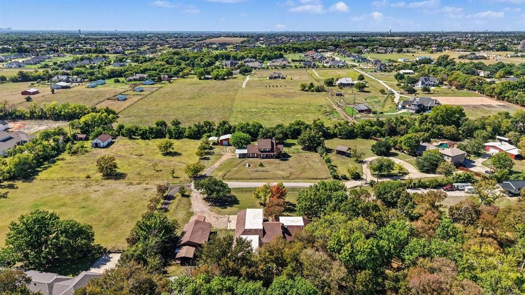 26 Brookhaven Drive, Lucas, TX 75002 Expansive property with a central residence, multiple accessory structures, and extensive open land