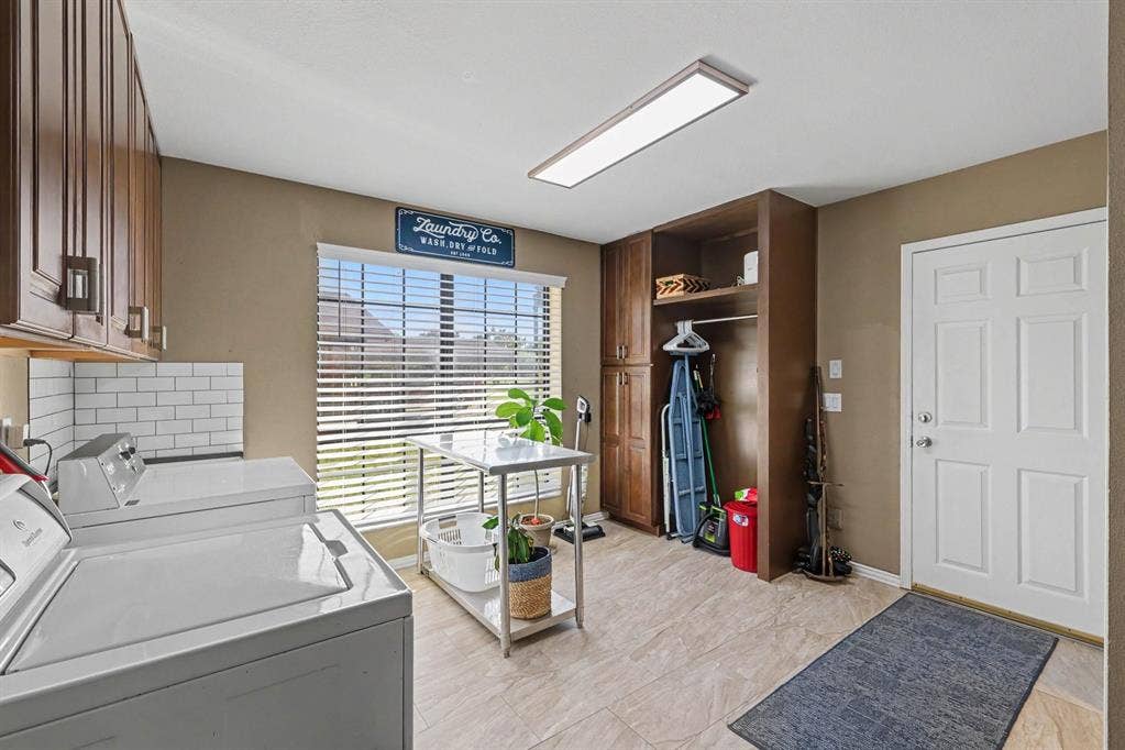26 Brookhaven Drive, Lucas, TX 75002 Upper wood-finish cabinetry, subway tile backsplash, tiled flooring, window with blinds, and built-in storage solutions