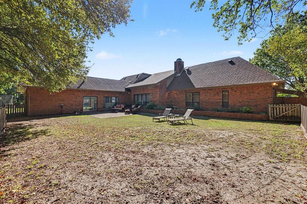 26 Brookhaven Drive, Lucas, TX 75002 Brick exterior with a shingle roof and multiple windows