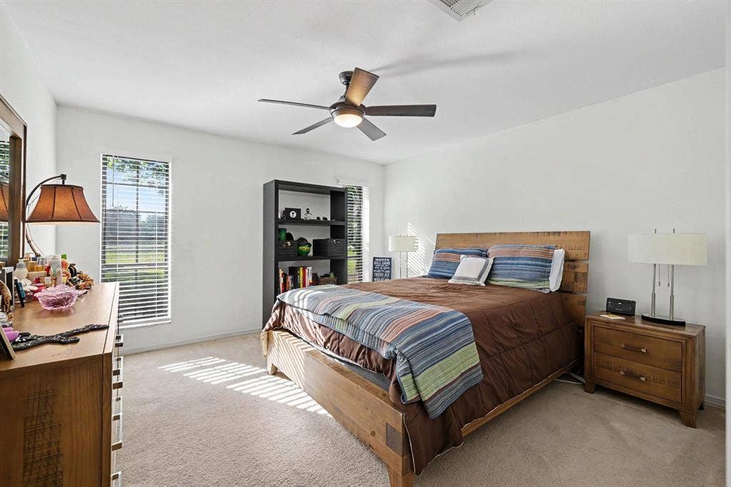 26 Brookhaven Drive, Lucas, TX 75002 Carpeted room with multiple windows providing natural light, a ceiling fan with integrated lighting, and white wall finishes