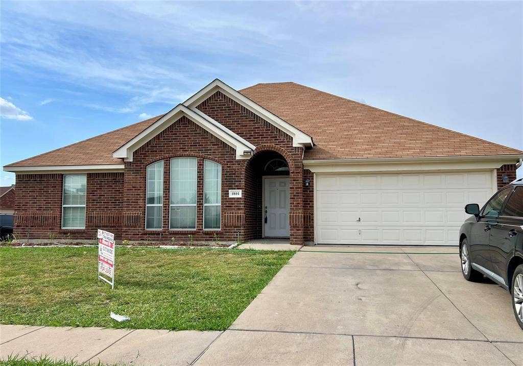 1801 Kathryn Court, Arlington, TX 76018 Brick exterior with an arched entryway, gabled roofline, and attached two-car garage