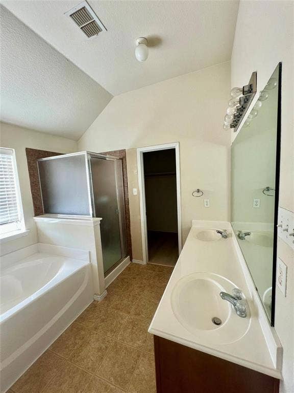 1801 Kathryn Court, Arlington, TX 76018 Bathroom featuring dual vanity with integrated sinks, built-in bathtub, glass-enclosed shower, and tile flooring