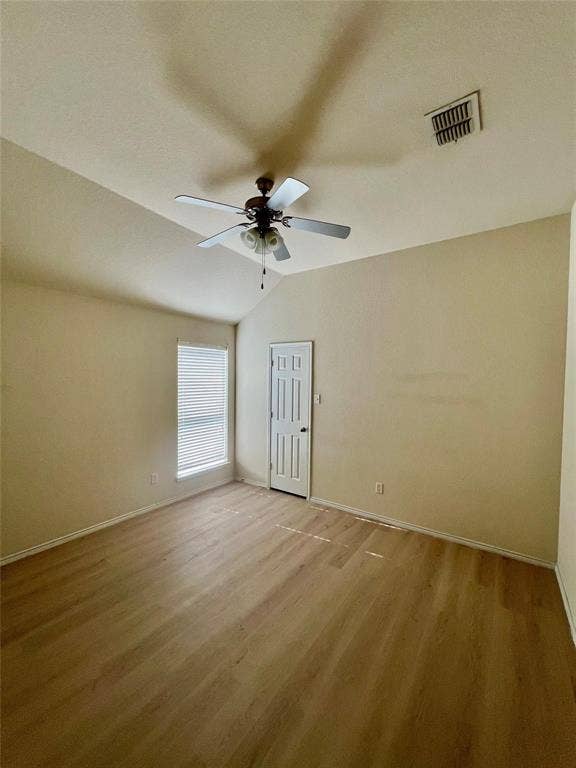 1801 Kathryn Court, Arlington, TX 76018 Room with wood-finish flooring, a vaulted ceiling, a ceiling fan, and a window with blinds
