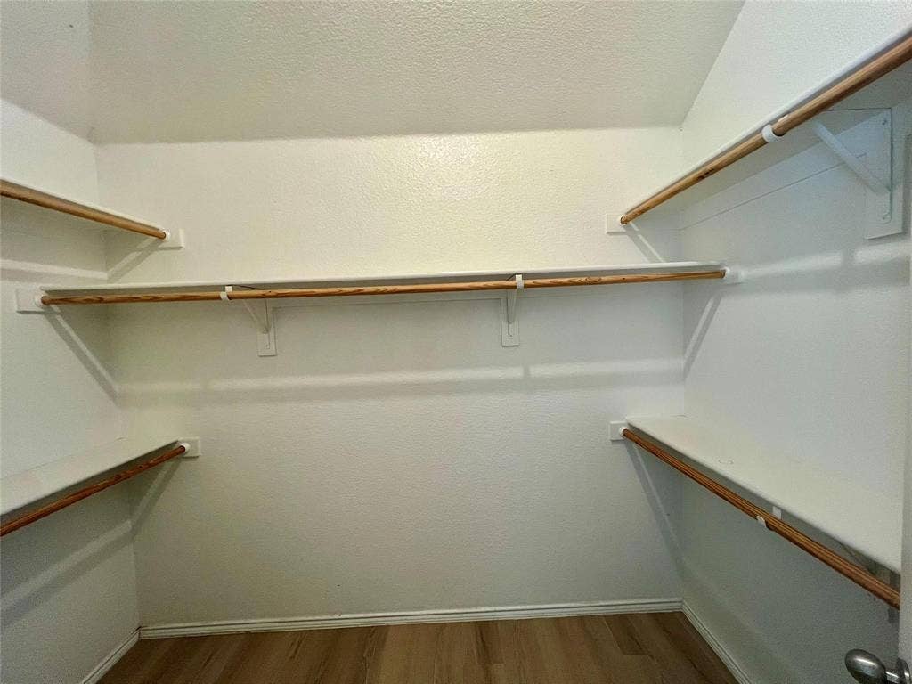 1801 Kathryn Court, Arlington, TX 76018 Walk-in closet with multiple shelves, wood-finish flooring, and white walls