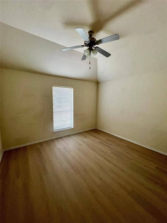 1801 Kathryn Court, Arlington, TX 76018 Vaulted ceiling with a ceiling fan, wood-finish flooring, and a window with blinds