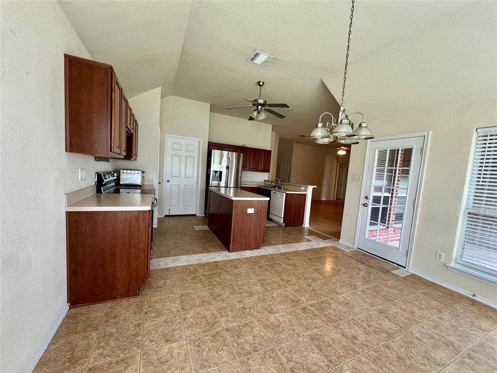 1801 Kathryn Court, Arlington, TX 76018 Vaulted ceilings with a ceiling fan, recessed lighting, and a glass-paneled door
