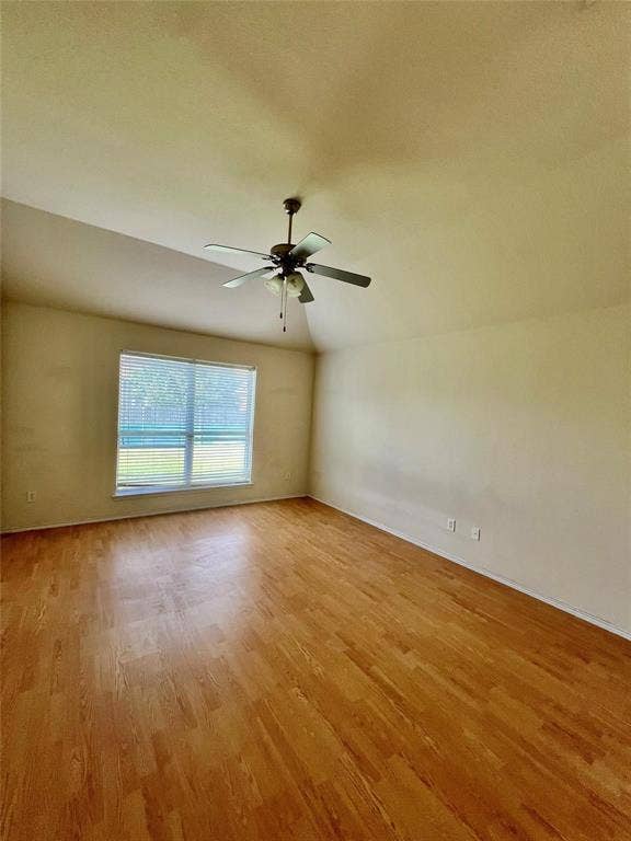 1801 Kathryn Court, Arlington, TX 76018 Vaulted ceiling with a ceiling fan, wood-finish flooring, and a large window with blinds