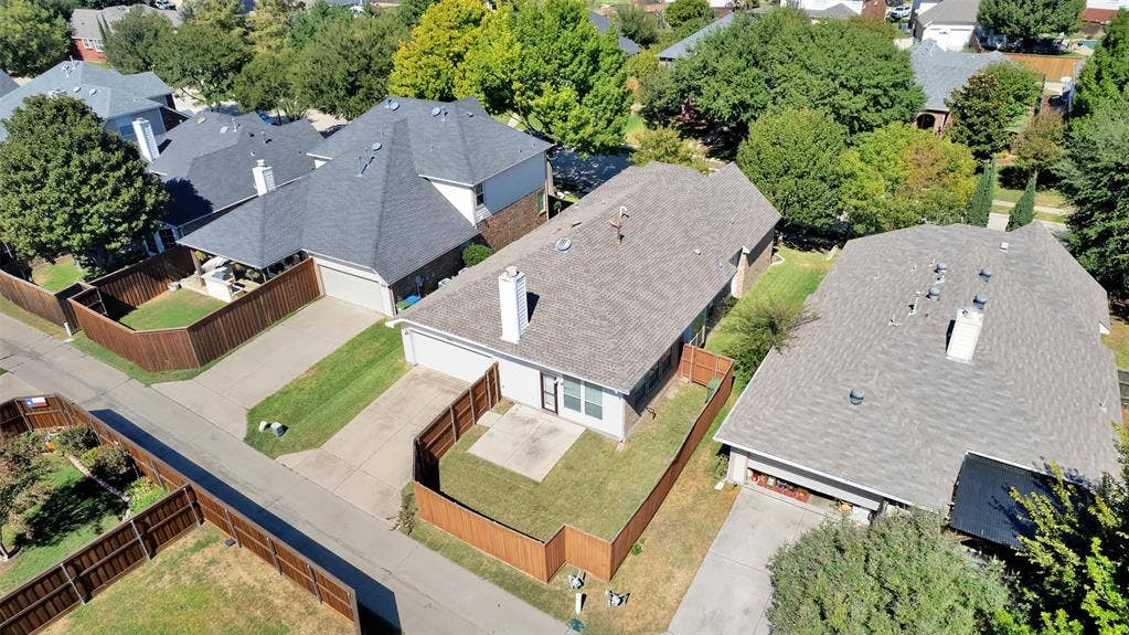 Attached garage with a paved driveway
