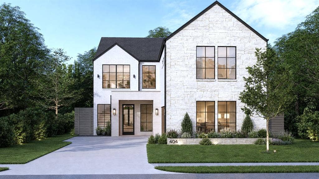 404 Cameron Avenue, Dallas, TX 75223 Contemporary residence featuring a white stone facade, black-framed windows, a covered entry with sconces, an integrated garage, and a manicured lawn