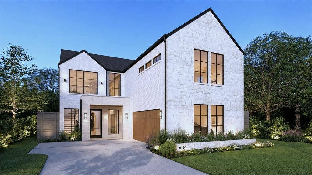 404 Cameron Avenue, Dallas, TX 75223 White brick exterior with black framed windows, prominent gables, and a wood-finish garage door