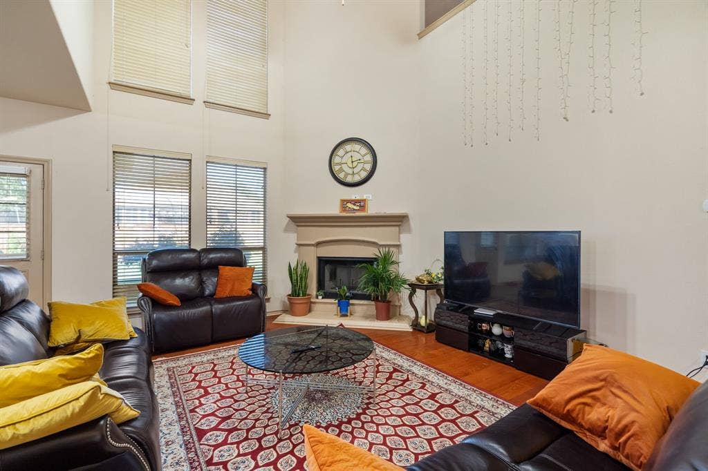 1620 Secretariat Lane, Irving, TX 75060 Living Room with 2-story ceiling, ceiling fan, lots of natural light, gas starter fireplace
