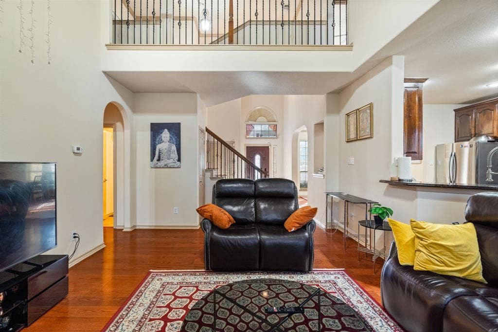 1620 Secretariat Lane, Irving, TX 75060 Living Room with 2-story ceiling, ceiling fan, lots of natural light, gas starter fireplace
