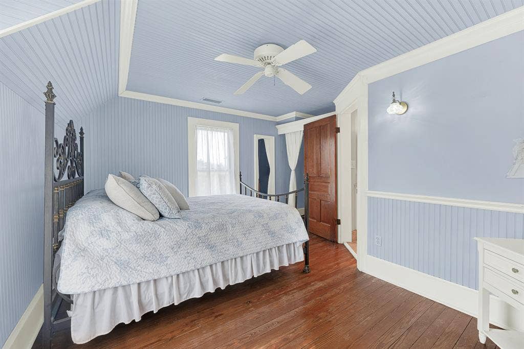 1425-1 Lone Star Road, Celina, TX 75009 Soft beadboard walls and ceilings, paired with restored original hardwood floors, create a bright, welcoming bedroom that feels both timeless and comfortable. Guests or family can settle in, open the windows, and enjoy the peaceful rhythm of country living.