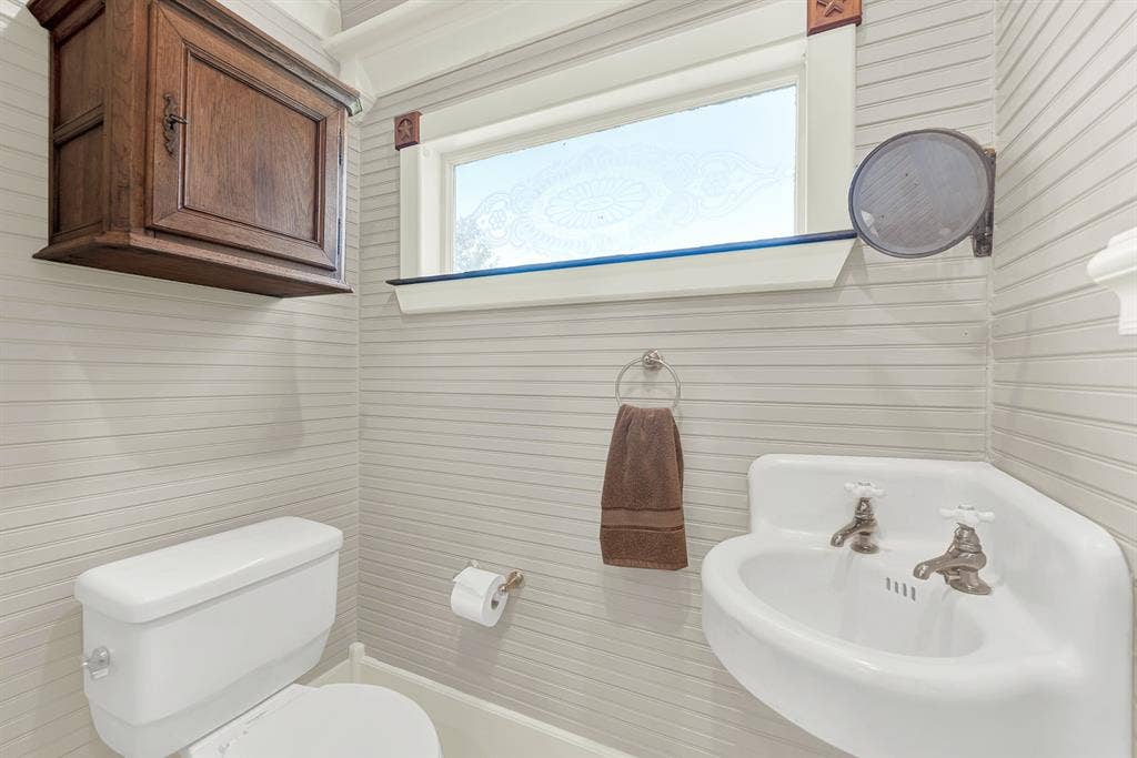 1425-1 Lone Star Road, Celina, TX 75009 Conveniently located for guests, this charming powder bath complements the home's historic character with classic fixtures, vintage-inspired details, and abundant natural light, offering both style and functionality.