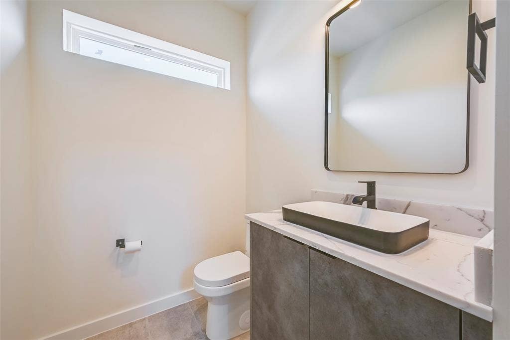2247 Mail Avenue, #102, Dallas, TX 75235 Contemporary vanity with a rectangular vessel sink, matte black faucet, and white countertop
