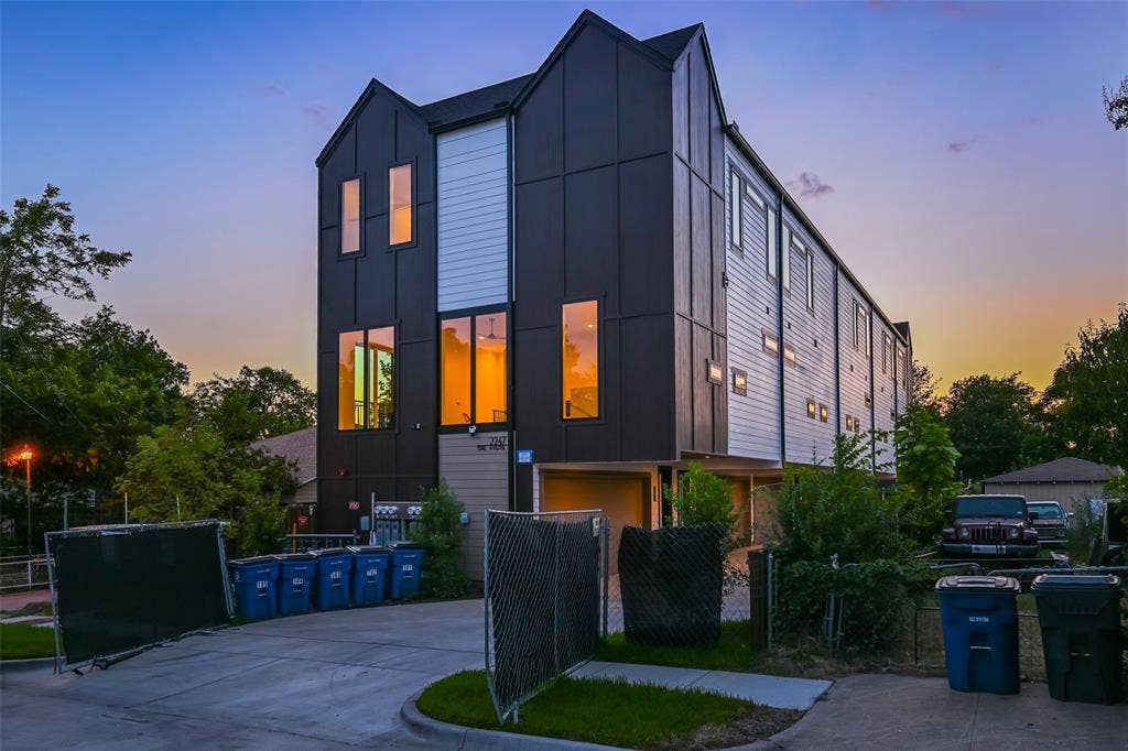 2247 Mail Avenue, #102, Dallas, TX 75235 Modern architectural exterior featuring contrasting dark and light siding, multiple large windows, and a multi-level design