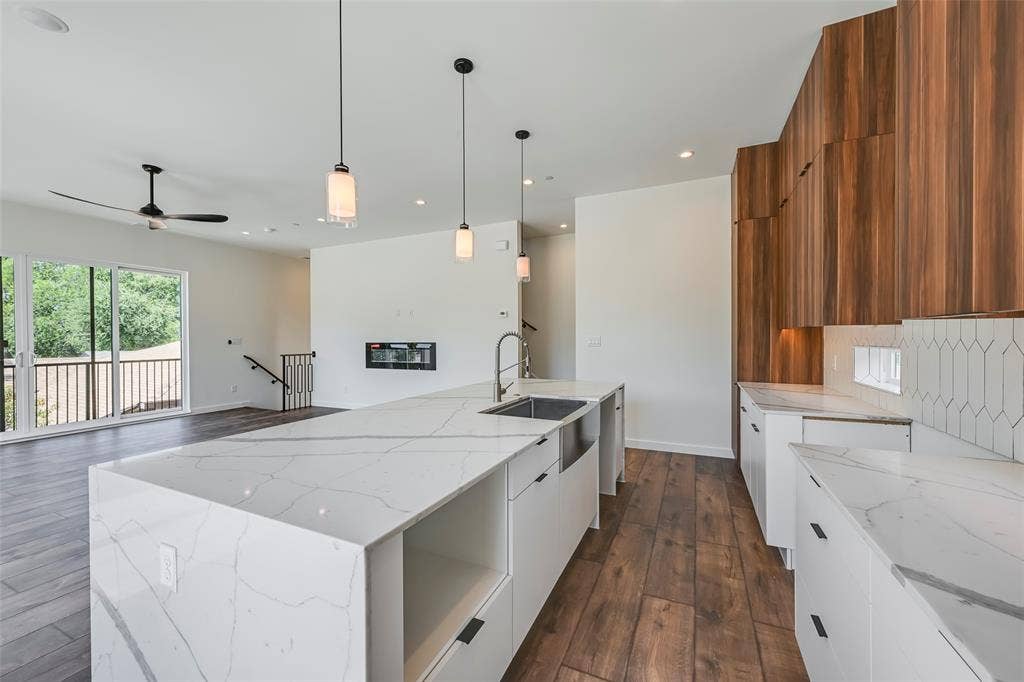 2247 Mail Avenue, #102, Dallas, TX 75235 Expansive kitchen island with a waterfall countertop, integrated sink, and pendant lighting