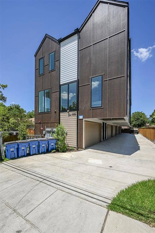 2247 Mail Avenue, #102, Dallas, TX 75235 Multi-level facade featuring dark vertical siding and white horizontal siding accents